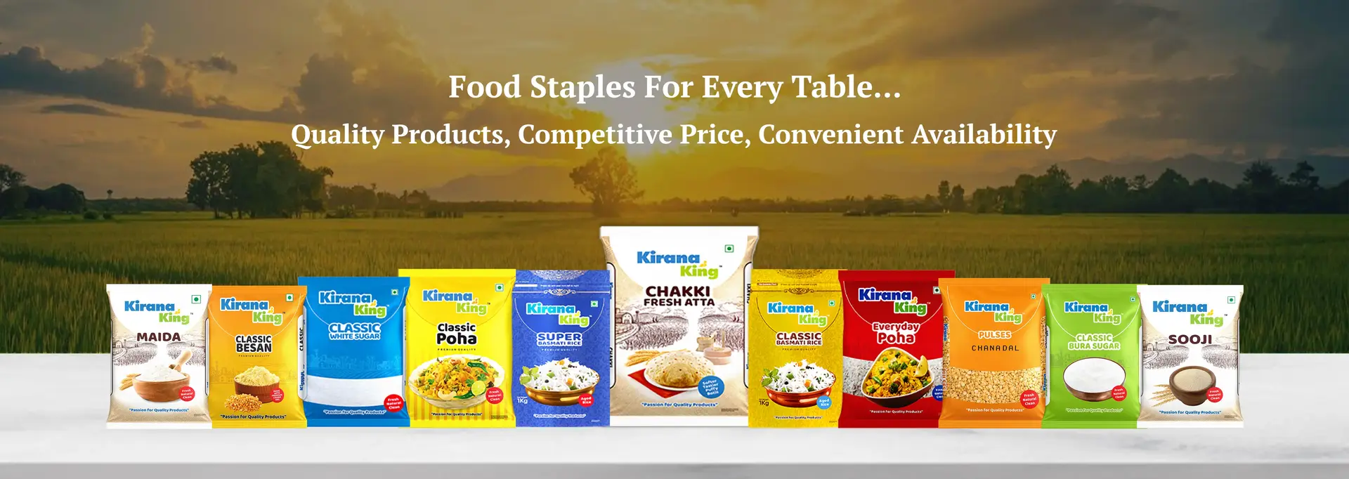 Sunrise over lush farmland with a wide view of nature’s bounty, featuring a vibrant array of Kirana King packaged staple grocery products—Chakki Fresh Atta, Rice, Sugar, Poha, Pulses, and Besan—symbolizing purity, freshness, and quality.